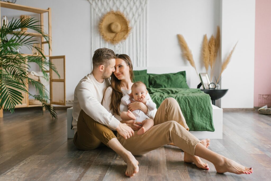 A happy family with a young son are resting in their cozy home